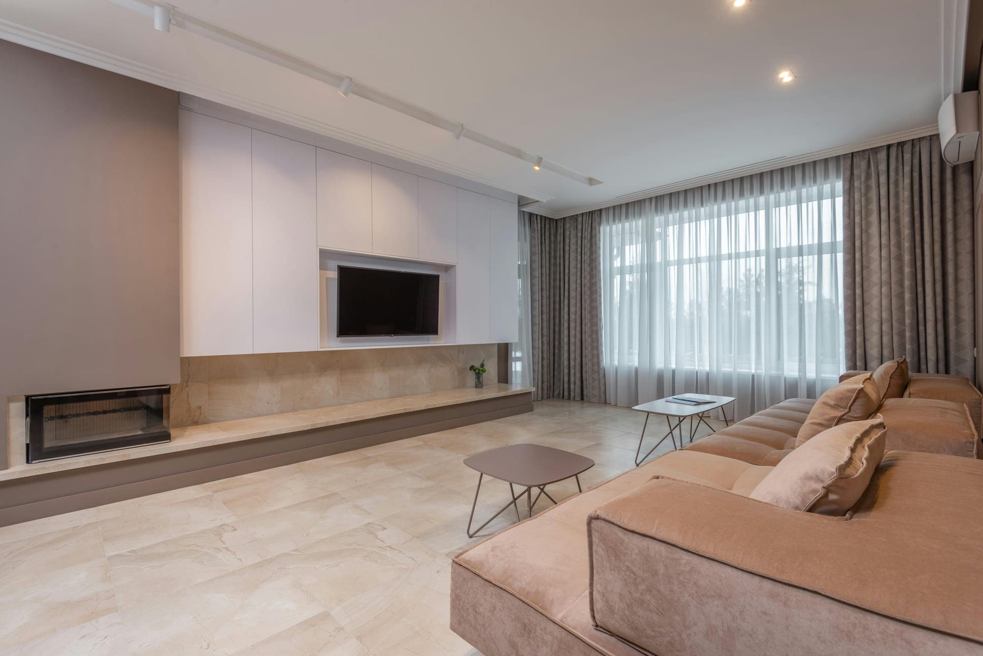 Freshly painted living room with a fireplace and built-in shelving